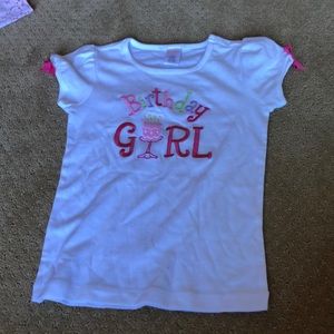 White tee with birthday gel embroidery.